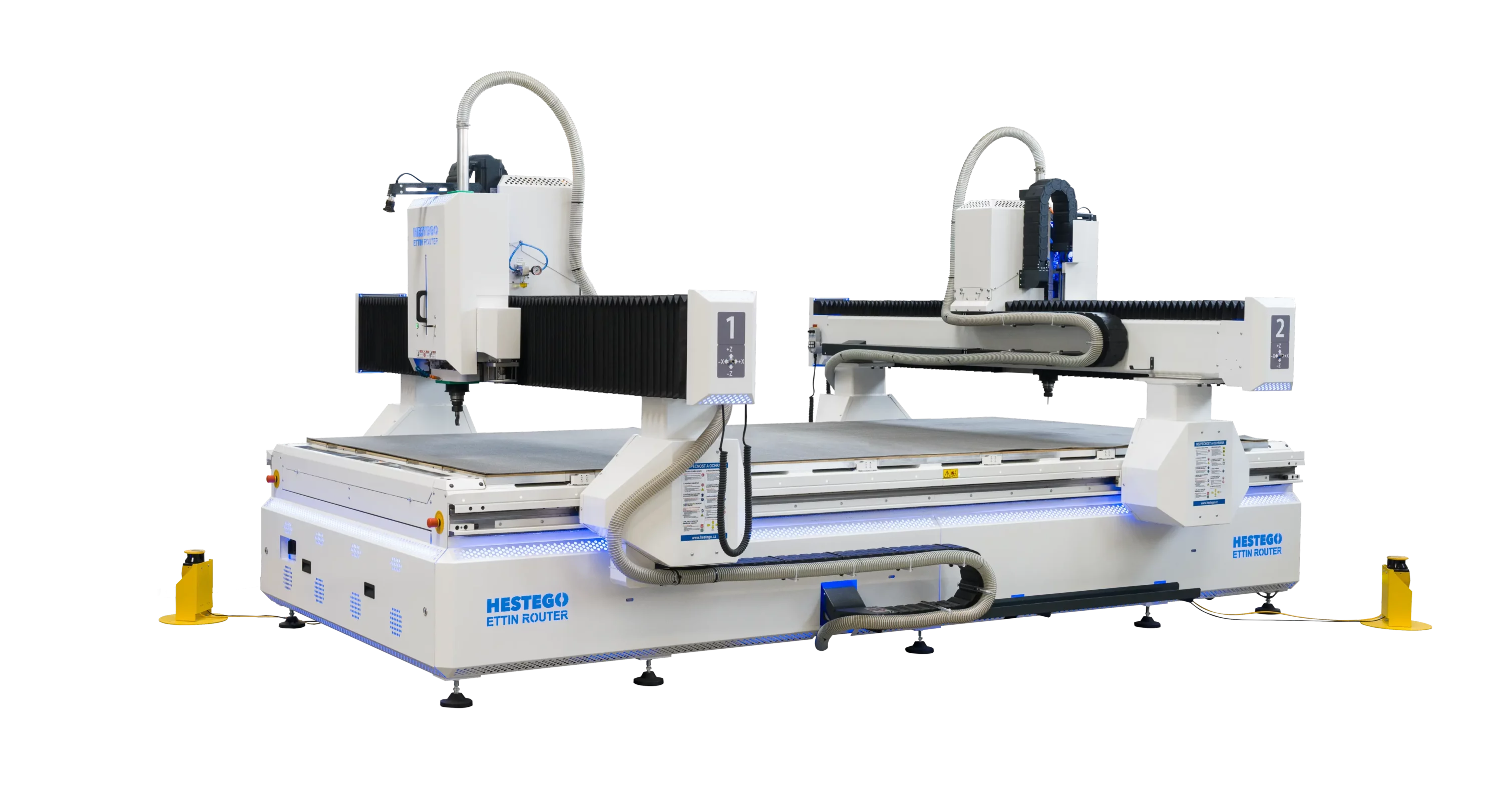Large industrial CNC router system with twin gantries, white frames, gray dust hoses, and blue accents on a black backdrop (brand: HESTEGO ETTIN ROUTER).